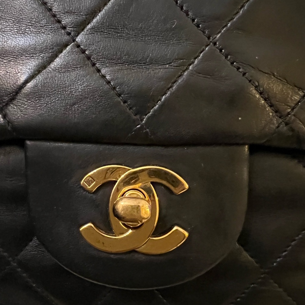 CHANEL Black Quilted Backpack with Gold Logo